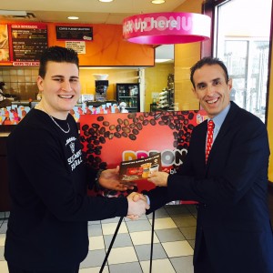 Dunkin’ Donuts Operations Director Lane Rodgers (right) presented Schalmont High School student-athlete Dante Gallucci with a $50 Dunkin’ Donuts card during the launch of the “Dunkin’ Donors Make a Difference” campaign at the Dunkin’ Donuts at 1636 Central Avenue in Albany, NY on Monday, January 5. Gallucci, who plays football, basketball and track at Schalmont, has a rare form of cancer and is an American Red Cross blood recipient. 