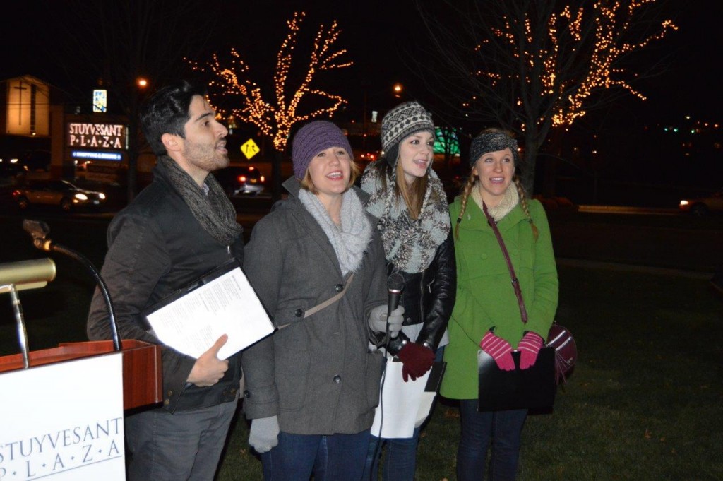 Performers from Park Playhouse sing a holiday song.