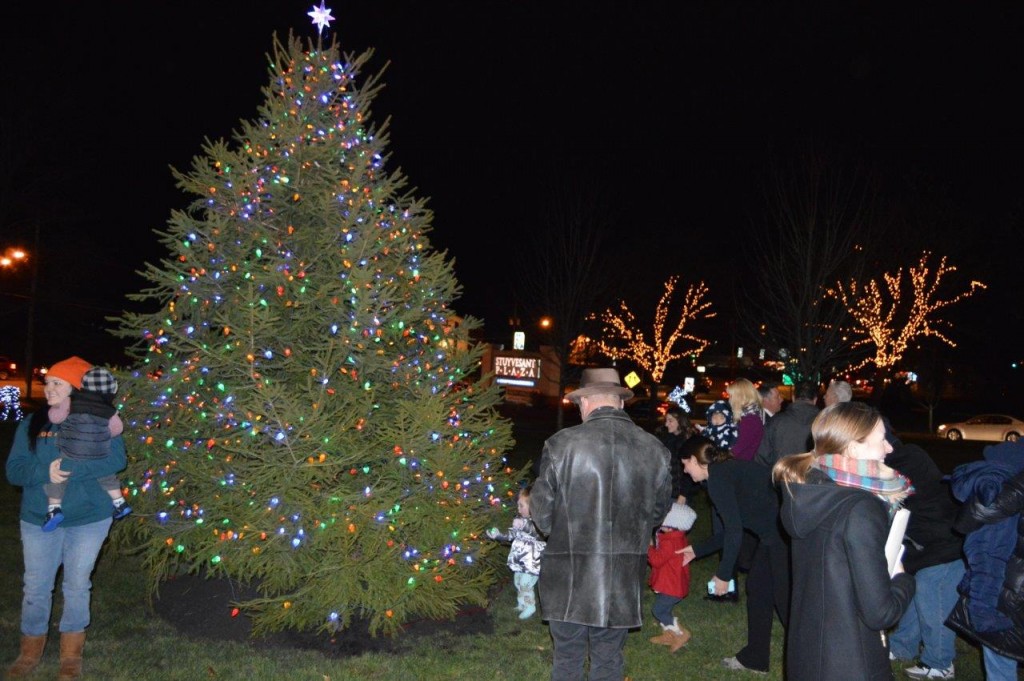 Shoppers gather to admire the decorative 14-foot holiday tree.