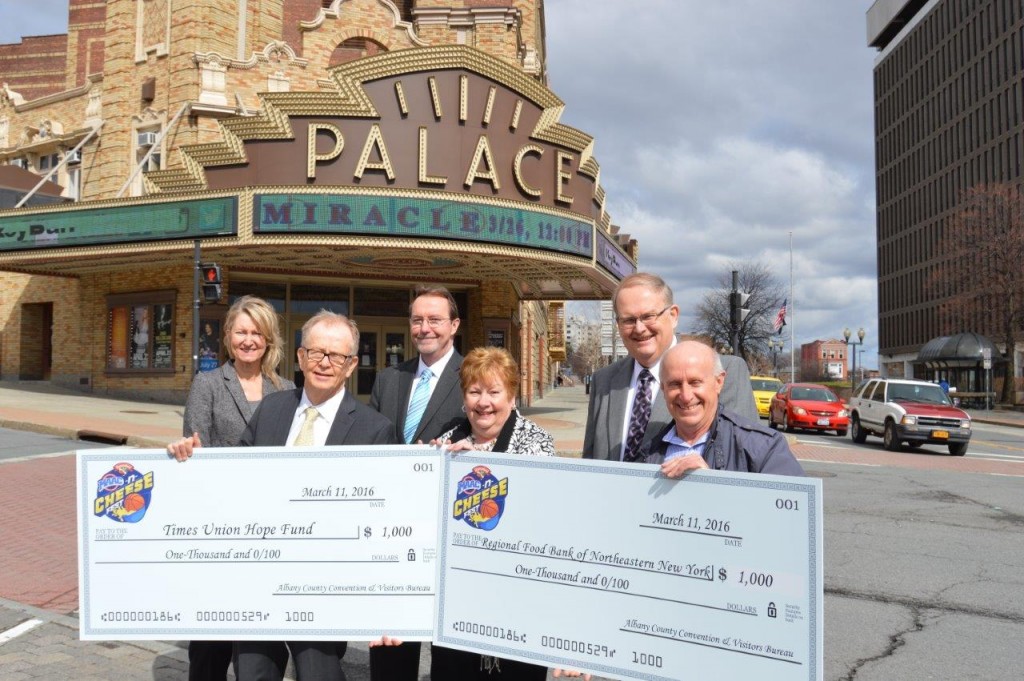 The Albany County Convention and Visitors Bureau (ACCVB) and Hannaford Supermarkets presented the Regional Food Bank of Northeastern New York and the Times Union Hope Fund each with a $1,000 check outside the Palace Theatre in Albany, NY on Friday, March 11. The non-profits were the beneficiaries of the Hannaford MAAC-n-Cheese Fest held on March 4 in celebration of the Metro Atlantic Athletic Conference (MAAC) Basketball Championships. The check presentations took place as the ACCVB and Times Union Center announced details of the NCAA Division I Men’s Ice Hockey East Regional and College Hockey Fest 2016 in downtown Albany on Saturday, March 26 and Sunday, March 27. Pictured (L to R) are Holly Brown, Executive Director, Palace Theatre; Mike Spain, Associate Editor, Times Union; Bob Belber, General Manager, Times Union Center; Michele Vennard, President and CEO, Albany County Convention and Visitors Bureau; Dave Farrell, Store manager, Hannaford Supermarkets; and Mark Quandt, Executive Director, Regional Food Bank of Northeastern New York; 