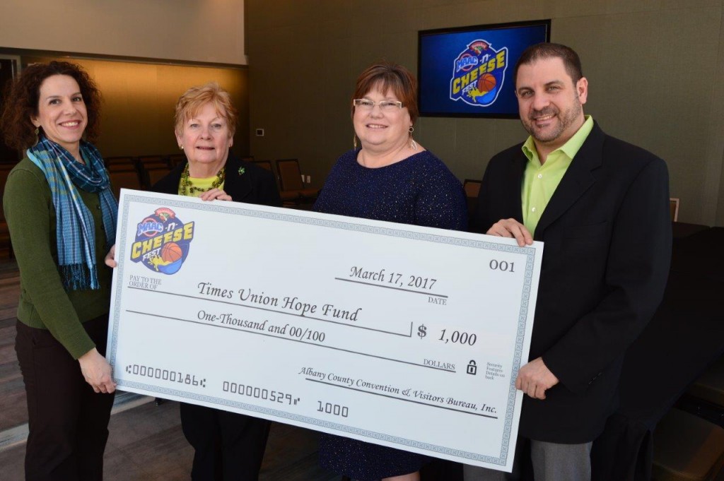 Albany County Convention and Visitors Bureau President and CEO Michele Vennard (second from left) is joined by Albany Capital Center General Manager Doug McClaine (right) and Hannaford Supermarkets Community Relations Coordinator Francesca Marino (left) to present a $1,000 donation to Times Union Hope Fund President Ruth Fantasia (second from right) at the Albany Capital Center on Friday, March 17. The Times Union Hope Fund served as the beneficiary of the second annual Hannaford MAAC-n-Cheese Fest, the official fan festival of the 2017 Metro Atlantic Athletic Conference Men's and Women's Basketball Championships. The event, which took place on March 3, was also the inaugural function at the Albany Capital Center. 