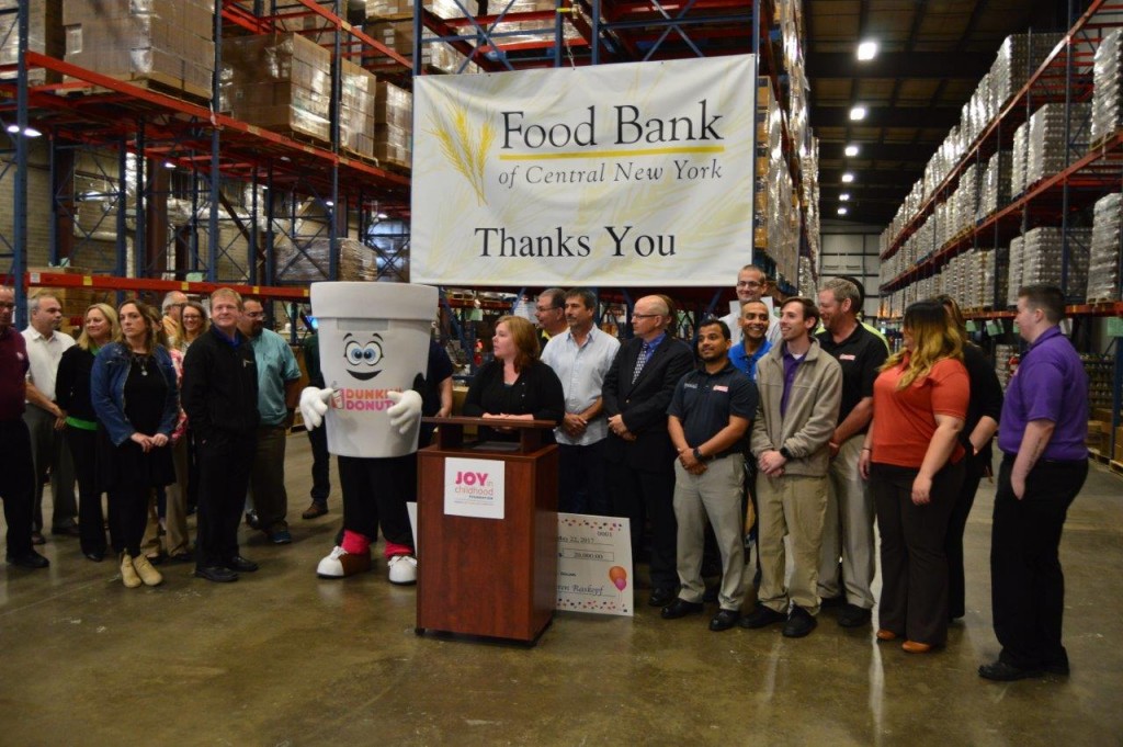 Food Bank of Central New York Chief Operating Officer Karen Belcher speaks during the press conference, flanked by Dunkin’ Donuts franchisees and associates.