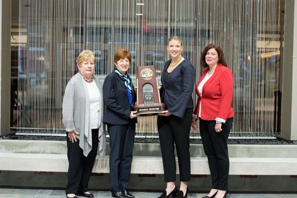 City of Albany Mayor Kathy Sheehan (second from left) and Siena women’s basketball head coach Ali Jaques (third from left) display the official championship trophy for the NCAA Women’s Basketball Albany Regional at the Times Union Center in Albany, NY. Mayor Sheehan and Coach Jaques were joined by Michele Vennard, president and CEO of the Albany County Convention and Visitors Bureau (left) and Georgette Steffens, executive director of the Downtown Albany Business Improvement District (right), 