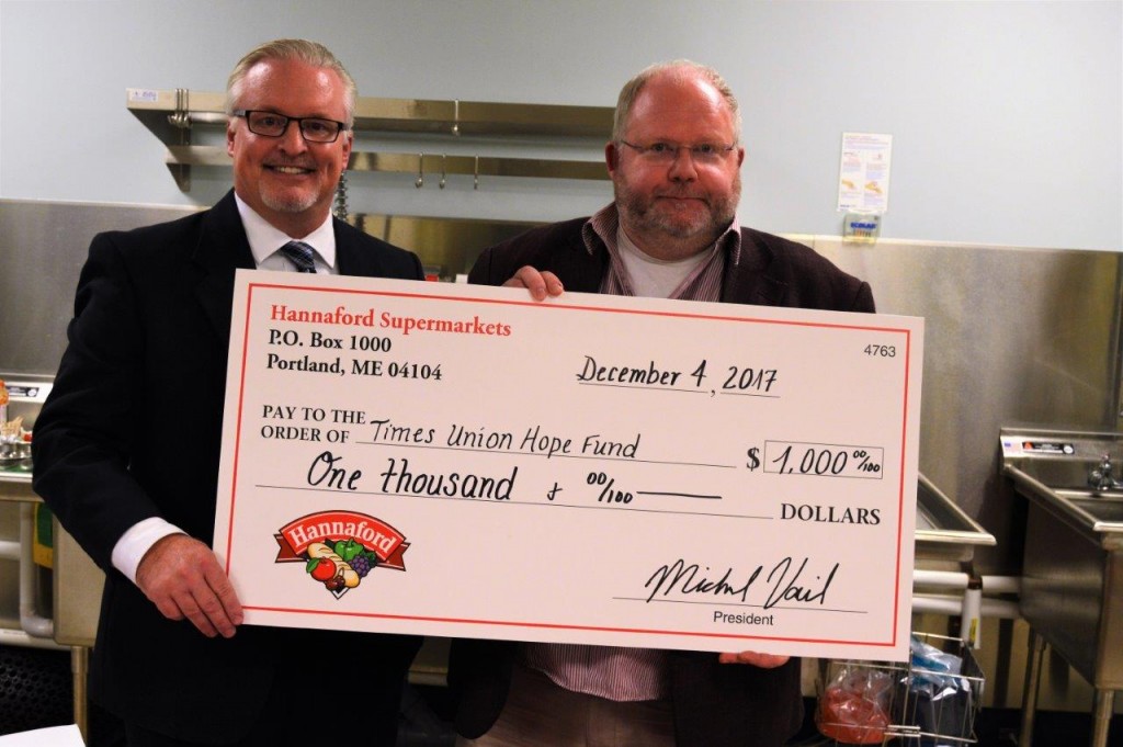 Hannaford Supermarkets Vice President of Retail Operations Jim Hamilton (left) presents Times Union Senior Writer and Table Hopping Columnist Steve Barnes (right) with a donation for the Times Union Hope Fund. 