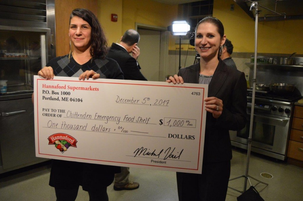 Hannaford Supermarkets Director of Operations Samara Bushey (right) presents Seven Days Food Writer Suzanne Podhaizer (left) with a donation for the Chittenden Emergency Food Shelf.