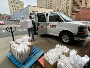 Cardona’s Market owner August Cardona unloads approximately 150 of the market’s signature sandwiches in preparation for a surprise lunch for healthcare workers and volunteers