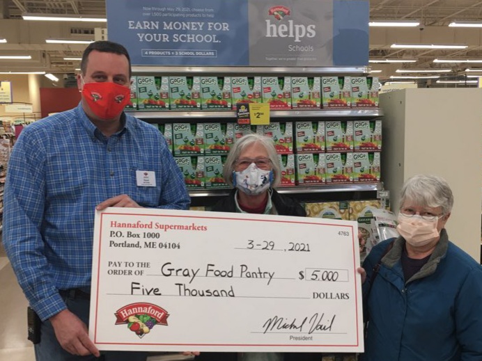 Hannaford Supermarkets Gray Store Manager John Reed (left) presents a $5,000 donation to Gray Community Food Pantry Directors Donna Rand (center) and Janet Nowinski (right) at the Gray Hannaford store