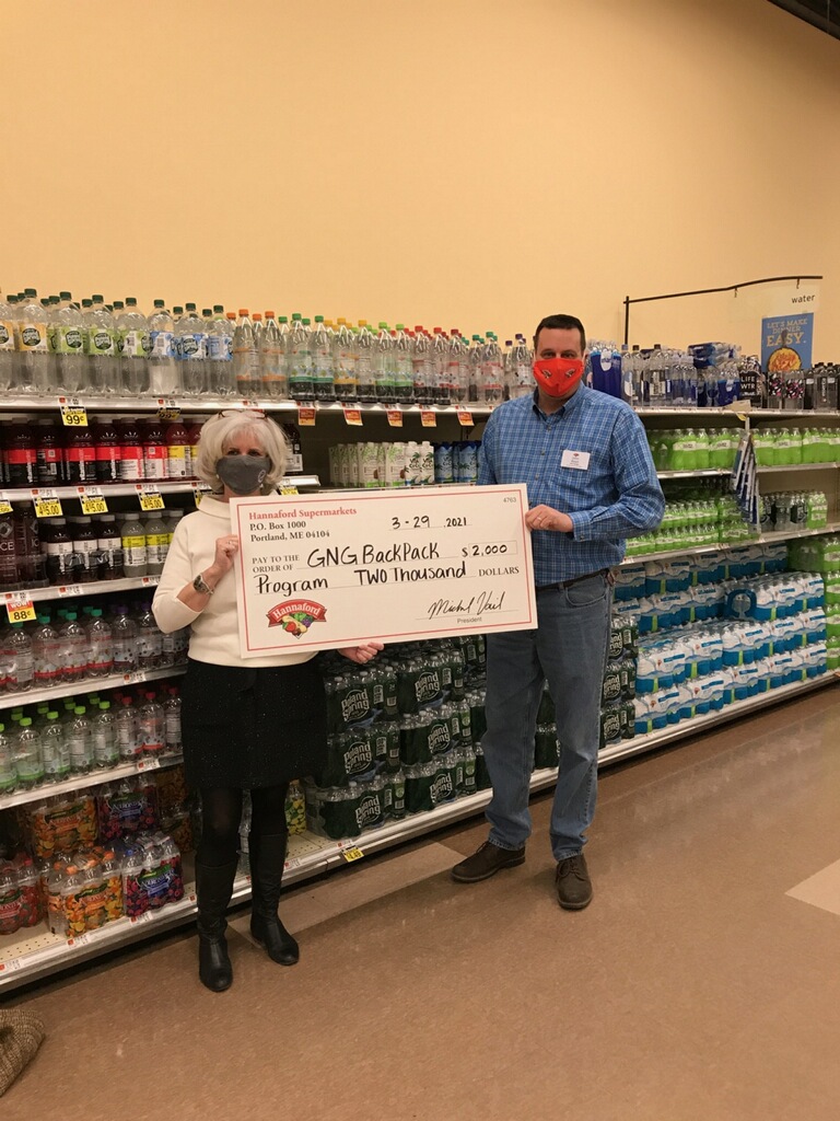 Hannaford Supermarkets Gray Store Manager John Reed (right) presents a $2,000 donation to Gray-New Gloucester Backpack Program Founder/Coordinator Donna Skilling (left) at the Gray Hannaford store