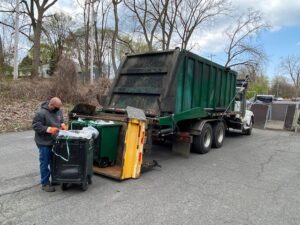 A driver with food waste recycling company Agri-Cycle Energy picks up compost bins filled with food waste.