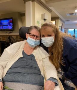 Wesley Health Care Center resident Barb Whitman (left) visits with Jennifer Kelly (right)
