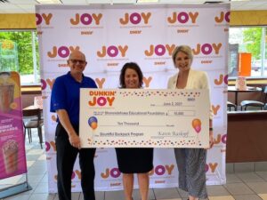Dunkin’ Field Marketing Manager Eric Stensland (left) and Dunkin’ Operations Manager Nicole Pecori (right) present Shenendehowa Central School District Director of Policy and Community Development Rebecca Carman (center) with a $10,000 grant.